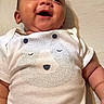 baby, smiling, infant, onesie, bear_print, clothing, happy, face, skin, arm, cute, child, portrait, indoors, person, newborn, baby_girl, baby_boy, expression, lying_down