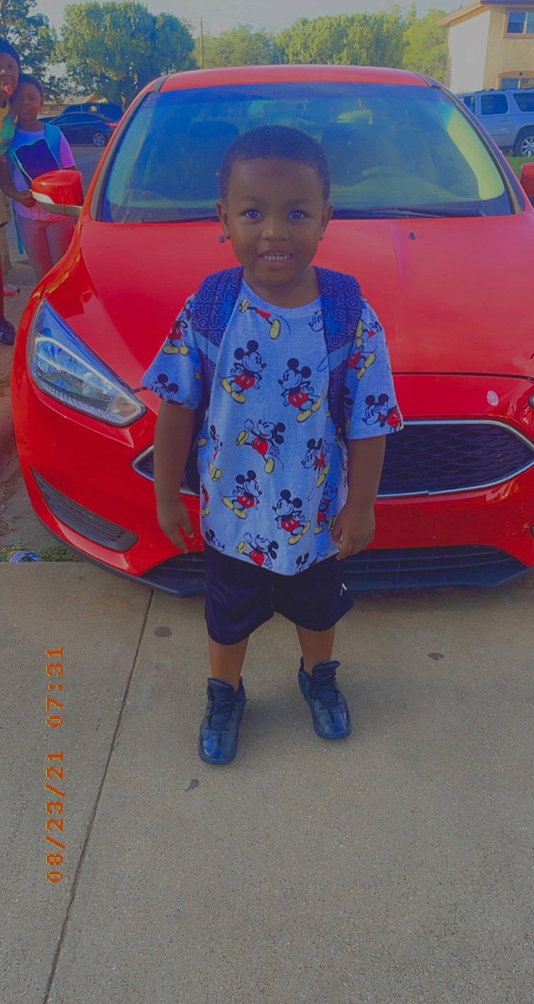 Jabari joined the competition — help win amazing prizes! alloy_wheel, automotive_design, automotive_exterior, automotive_lighting, automotive_tire, blue, bumper, car, green, hood, land_vehicle, motor_vehicle, person, personal_luxury_car, red, rim, tire, trunk, under_exposed, vehicle