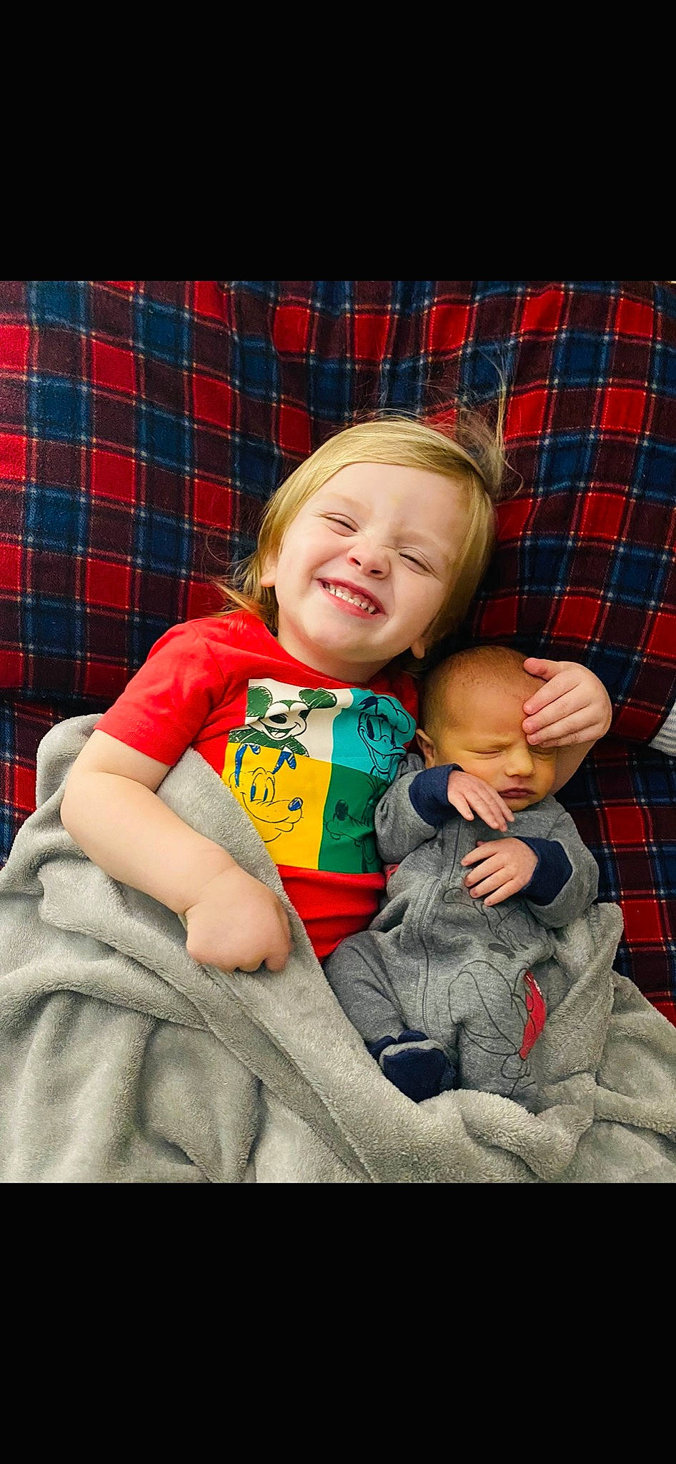 Hunter is registered to the contest to win money with this photo: arm, baby, baby_toddler_clothing, cheek, child, comfort, eye, fun, happy, head, human_body, joy, lap, pattern, person, plaid, sitting, skin, sleeve, smile