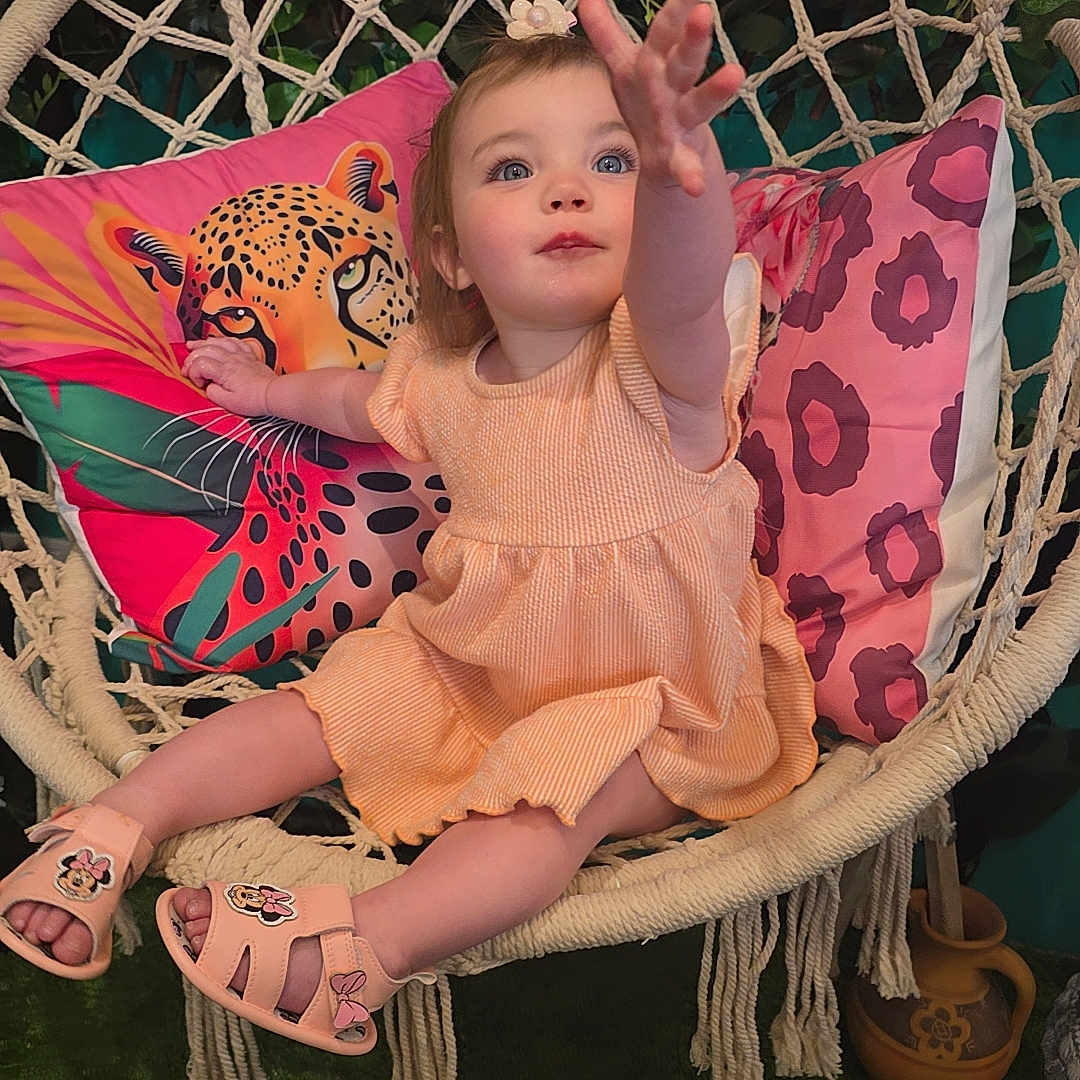 Elysia joined the competition — help win amazing prizes! child, colorful, cute, decor, dress, flower, furniture, greenery, happy, indoor, macrame, patterned, pillow, plant, pottery, reaching, sandal, smiling, swing_chair, toddler