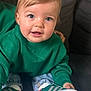 toddler, child, green_sweater, blue_eyes, sneakers, jeans, couch, indoor, casual_clothing, portrait, cute, smiling, sitting, young_child, person, comfortable, fashion, footwear, happy, closeup