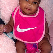 Alaya is registered to the contest to win money with this photo: baby, babylaughing, bib, bodypart, clothing, cushion, face, happy, head, homedecor, indoors, mouth, person, photography, portrait, purple, shorts, sitting, smile, teeth