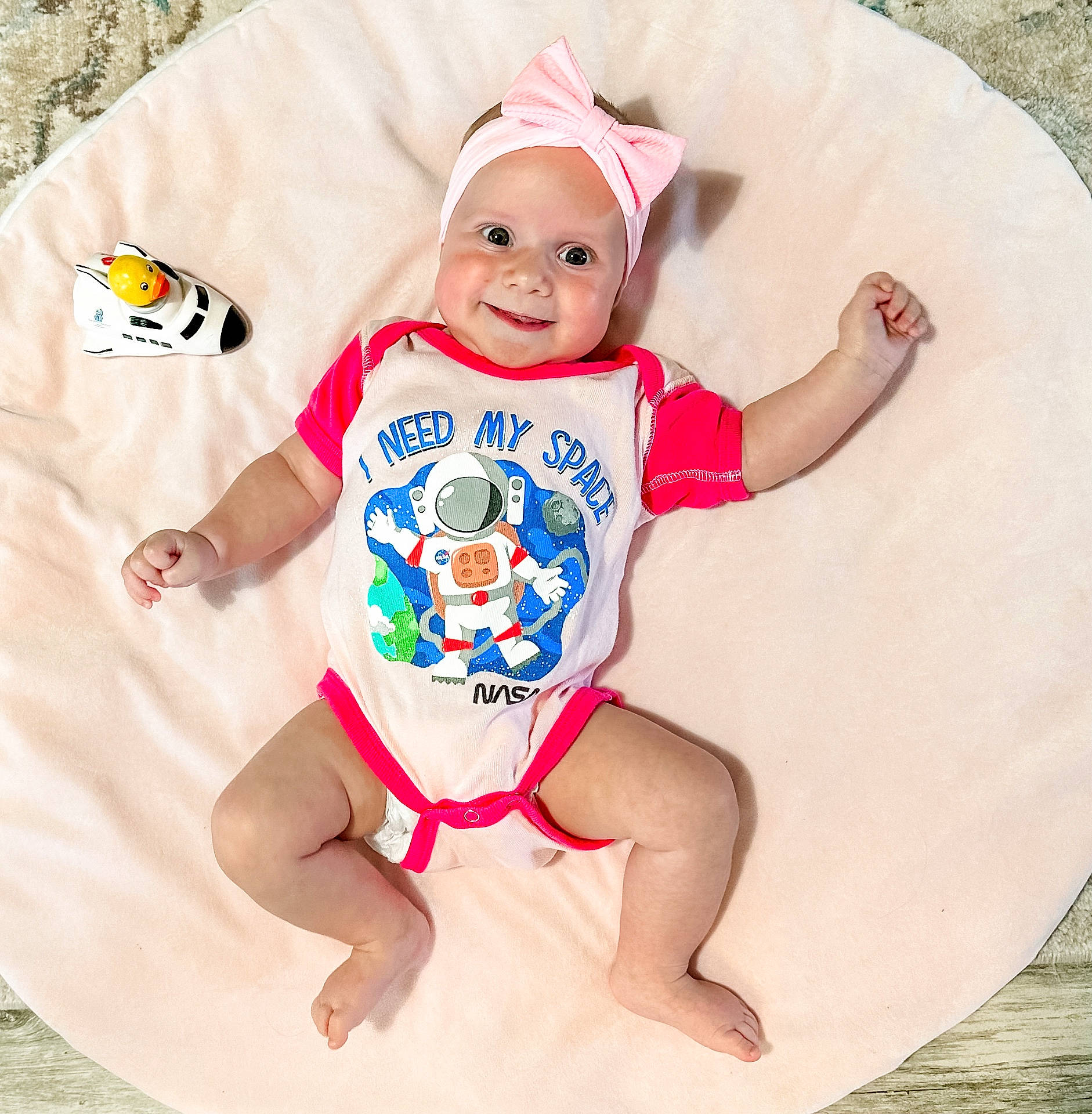 Lainey joined the competition — help win amazing prizes! applique, baby, bodypart, bonnet, cap, clothing, diaper, face, finger, furniture, hand, happy, hat, head, pattern, person, photography, portrait, sitting, t_shirt