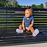 toddler, child, bench, outdoor, park, grass, trees, blue_sky, sunny, smiling, sitting, clothing, socks, daylight, nature, happy, casual, portrait, social_media, music_overlay