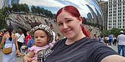 Na'Hijah is registered to the contest to win money with this photo: woman, baby, selfie, red_hair, leopard_print, hat, pink_clothing, cloud_gate, millennium_park, chicago, reflection, crowd, urban, skyscraper, outdoor, daytime, smile, tourist, cityscape, public_space
