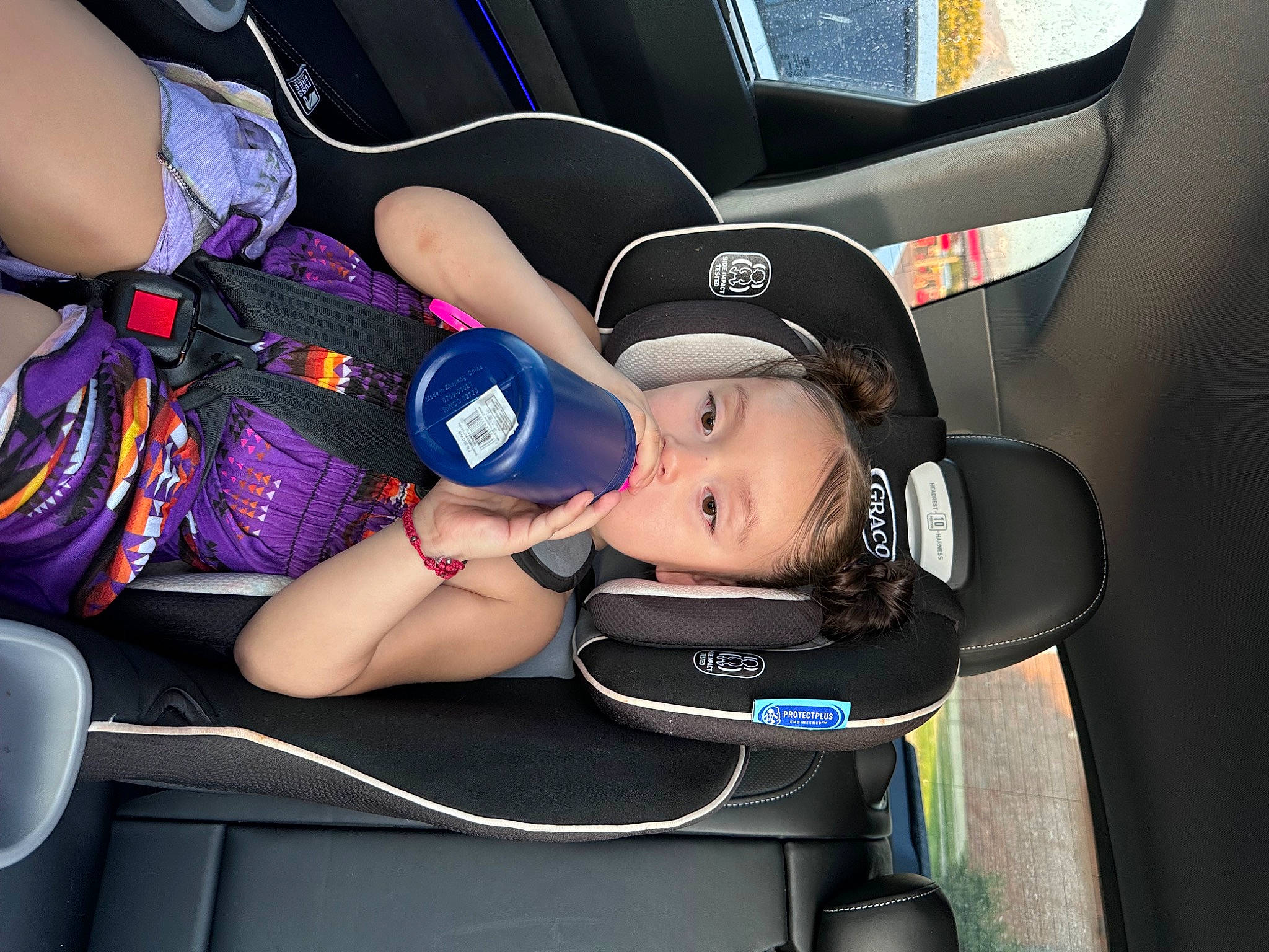 Priscilla is registered to the contest to win money with this photo: auto_part, baby, baby_carriage, baby_in_car_seat, baby_products, baby_safety, car_seat, child, comfort, electric_blue, fun, hat, head_restraint, person, personal_protective_equipment, service, steering_part, steering_wheel, thigh, toddler