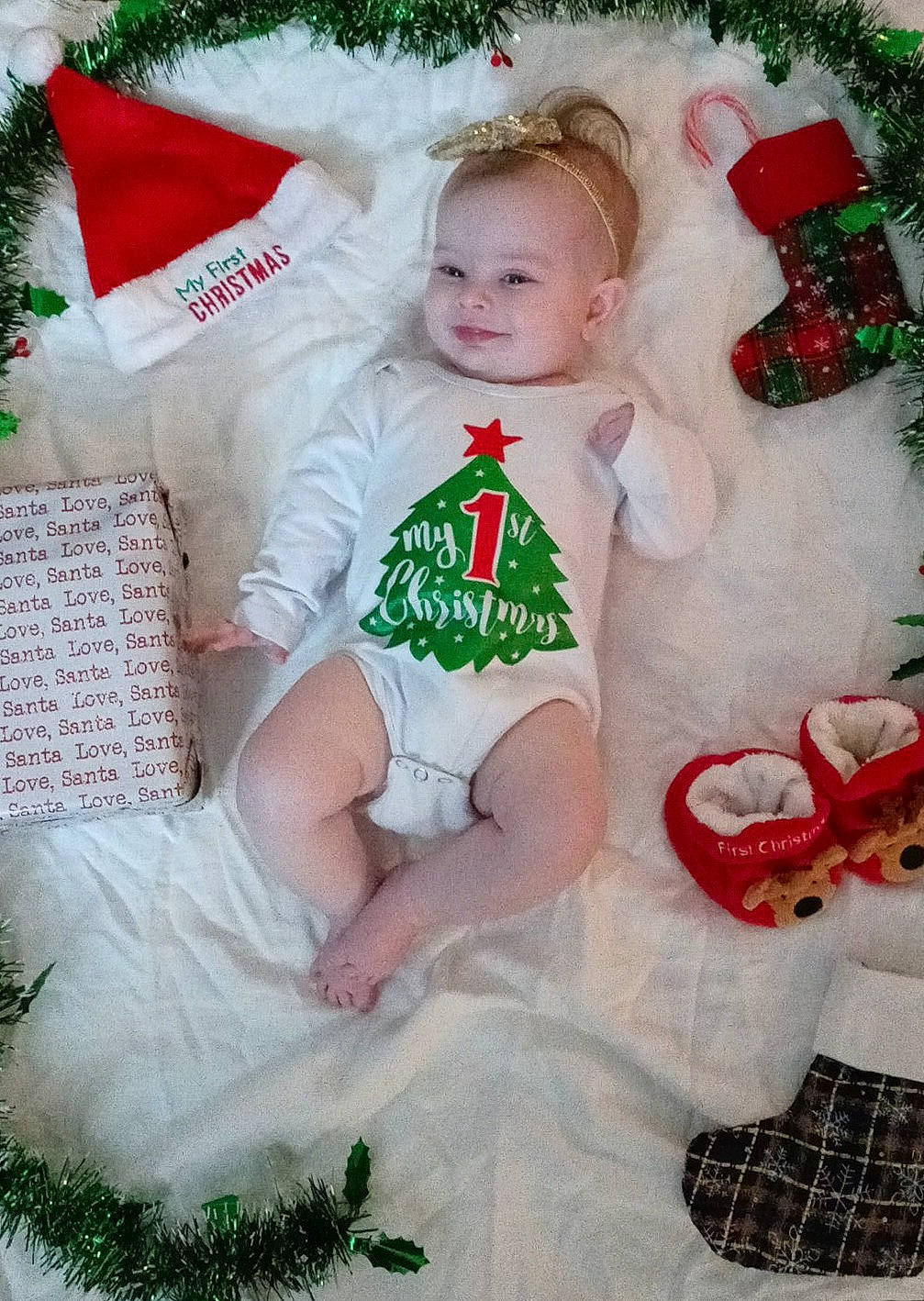 Savannah is registered to the contest to win money with this photo: baby, baby_toddler_clothing, child, christmas, christmas_decoration, christmas_eve, christmas_ornament, event, fictional_character, grass, green, happy, holiday, holiday_ornament, interior_design, ornament, pattern, person, sleeve, textile