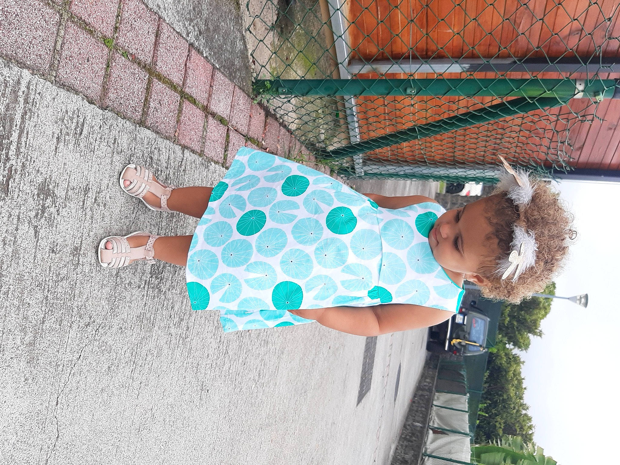 Lyena participe au concours pour gagner de l'argent avec cette photo : aqua, baby_toddler_clothing, brick, brickwork, day_dress, foot, pattern, person, polka_dot, sandal, street_fashion, sunglasses, teal, turquoise, walking_shoe