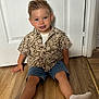 blue_eyes, boy, casual_clothing, child, cute, denim_shorts, door, floor, hair, happy, home, indoor, portrait, shirt, sitting, smiling, socks, toddler, wooden_floor, young_child