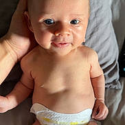 Ada joined the competition — help win amazing prizes! baby, infant, diaper, hand, skin, face, eyes, smile, lying_down, bed, blanket, cute, child, newborn, person, human, soft, comfort, tender, support