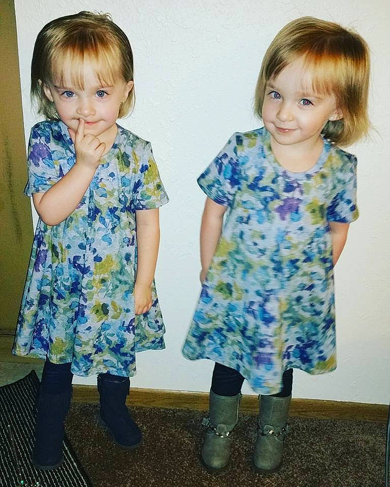 Mila &amp; Mylee Bowser is registered to the contest to win money with this photo: child, clothing, day, dress, fun, girl, human_hair_color, joy, material, outerwear, pattern, person, sleeve, smile, standing, textile, toddler