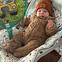Ethan is registered to the contest to win money with this photo: baby, infant, onesie, beanie, baby_rocker, balloon, cocomelon, fuzzy_clothing, indoor, wooden_floor, patterned_fabric, child, cute, relaxed, seated, toy, colorful, soft_texture, headwear, small_hand
