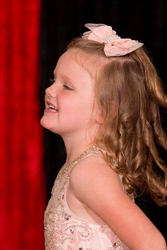 Hannah is registered to the contest to win money with this photo: chin, dress, eyebrow, eyelash, facial_expression, fashion, flash_photography, hair, hairstyle, happy, head, human, iris, joy, lip, neck, organ, person, pink, skin