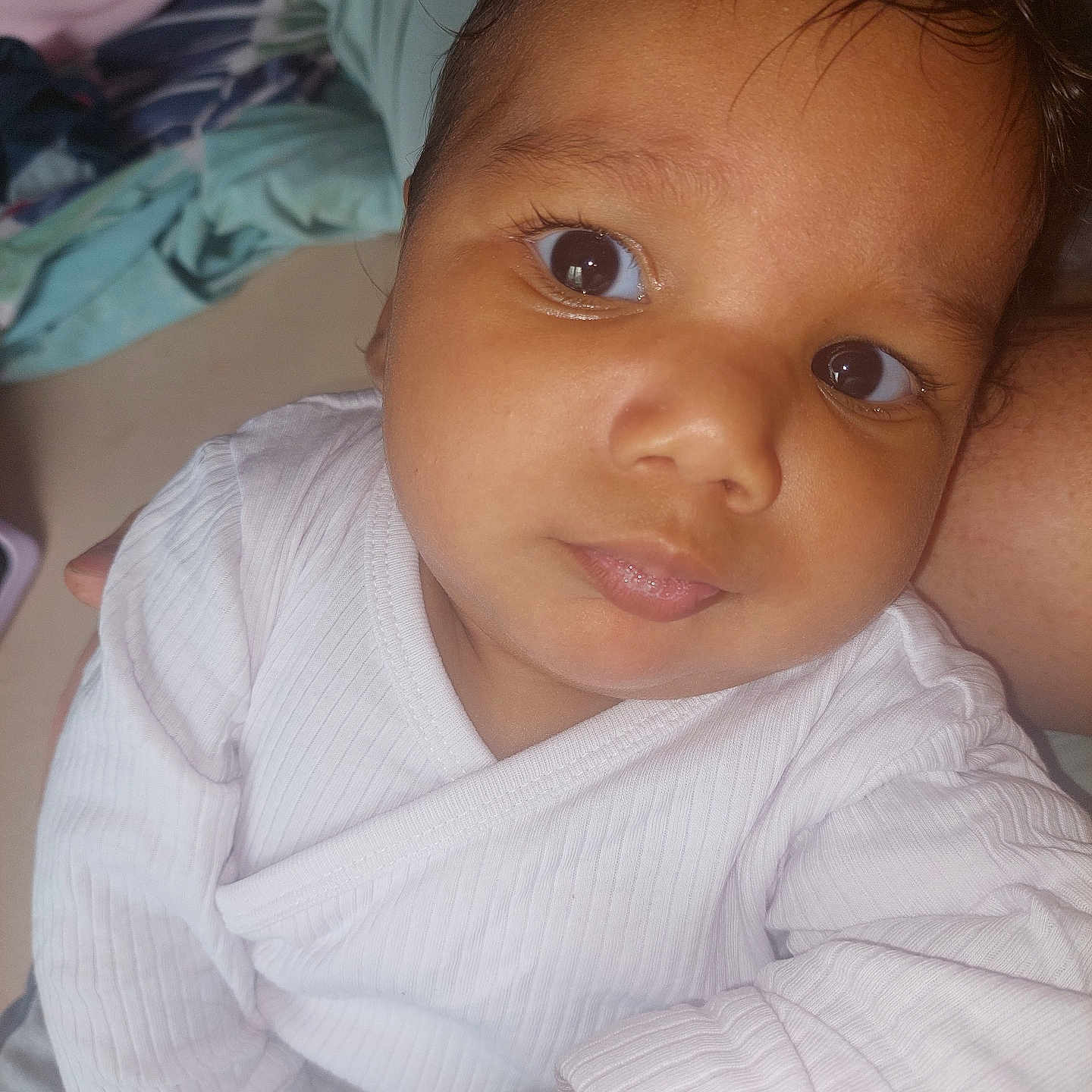 Jean-Brahim a rejoint le concours — aidez-le/la à gagner de superbes lots ! baby, child, closeup, curly_hair, cute, expression, eyes, face, head, human, indoor, infant, looking_away, person, portrait, skin, sleeve, soft_light, white_clothing, young_child