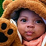 baby, child, face, costume, bear, plush, paw, hood, fur, cute, expression, outdoor, greenery, portrait, infant, clothing, zipper, closeup, adorable, person