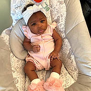 Kamora joined the competition — help win amazing prizes! baby, infant, headband, pink_clothing, booties, baby_seat, patterned_fabric, animal_print, curious_expression, indoor, soft_lighting, cute, child, cozy, toddler, smiling, person, small_hands, footwear, comfortable