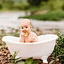 baby, bathtub, lemon, outdoor, nature, greenery, rocks, infant, curious, sitting, cute, small_bathtub, fruit, cheeks, portrait, child, water, fresh, natural_light, playful