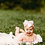 Ryleigh is registered to the contest to win money with this photo: baby, smiling, pink_bow, blanket, grass, outdoor, infant, happy, headband, nature, child, cute, portrait, summer, greenery, baby_dress, lying_down, one_person, fun, baby_girl