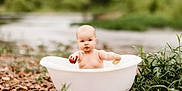 Ryleigh joined the competition — help win amazing prizes! baby, tub, outdoor, nature, pebbles, greenery, fruit, curious, child, small, white, water, playing, summer, cute, portrait, infant, holding, exploring, natural