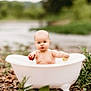 baby, tub, outdoor, nature, pebbles, greenery, fruit, curious, child, small, white, water, playing, summer, cute, portrait, infant, holding, exploring, natural