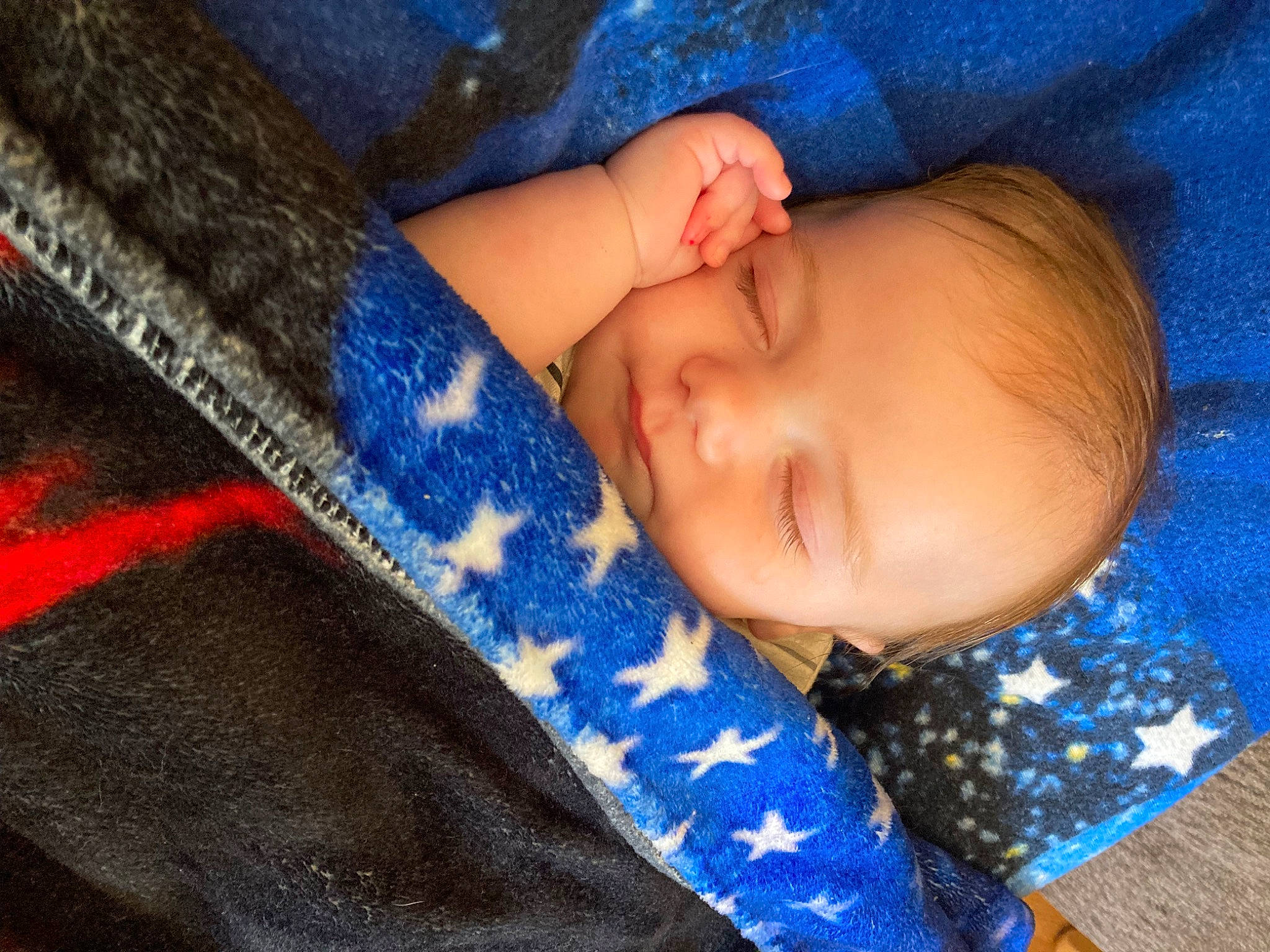 Everett is registered to the contest to win money with this photo: azure, baby, baby_toddler_clothing, beauty, bedtime, blue, child, close_up, comfort, electric_blue, finger, linens, nail, nose, pattern, person, skin, sleeve, textile, toddler