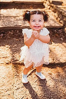 Amayah joined the competition — help win amazing prizes! baby_toddler_clothing, beauty, child, day_dress, eye, flash_photography, footwear, fun, grass, hair, hairstyle, happy, head, joy, peach, people_in_nature, person, portrait_photography, sandal, sitting