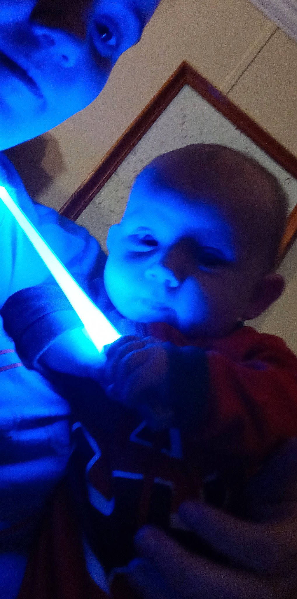 Laura is registered to the contest to win money with this photo: automotive_lighting, azure, baby, baby_toddler_clothing, blue, child, darkness, electric_blue, entertainment, fun, helmet, magenta, person, personal_protective_equipment, purple, room, t_shirt, technology, toddler, violet