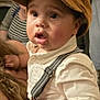 Elijah joined the competition — help win amazing prizes! baby, child, cap, brown_cap, white_shirt, suspenders, indoor, person, hand, face, curly_hair, expression, surprised, adult, background, window, glasses, people, holding, closeup