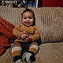 Elijah joined the competition — help win amazing prizes! baby, child, smiling, couch, sitting, sweater, striped_leggings, cozy, indoor, furniture, happy, cute, portrait, infant, home, plush, soft, warm, hands, feet