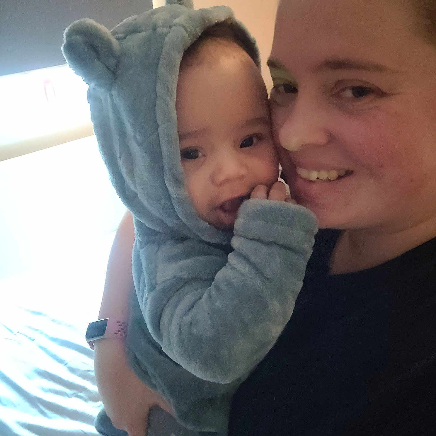 Elijah is registered to the contest to win money with this photo: adult, baby, bed, blanket, child, cozy, cute, face, fuzzy, happy, holding, home, hoodie, indoor, parent, person, portrait, smiling, toddler, wearing