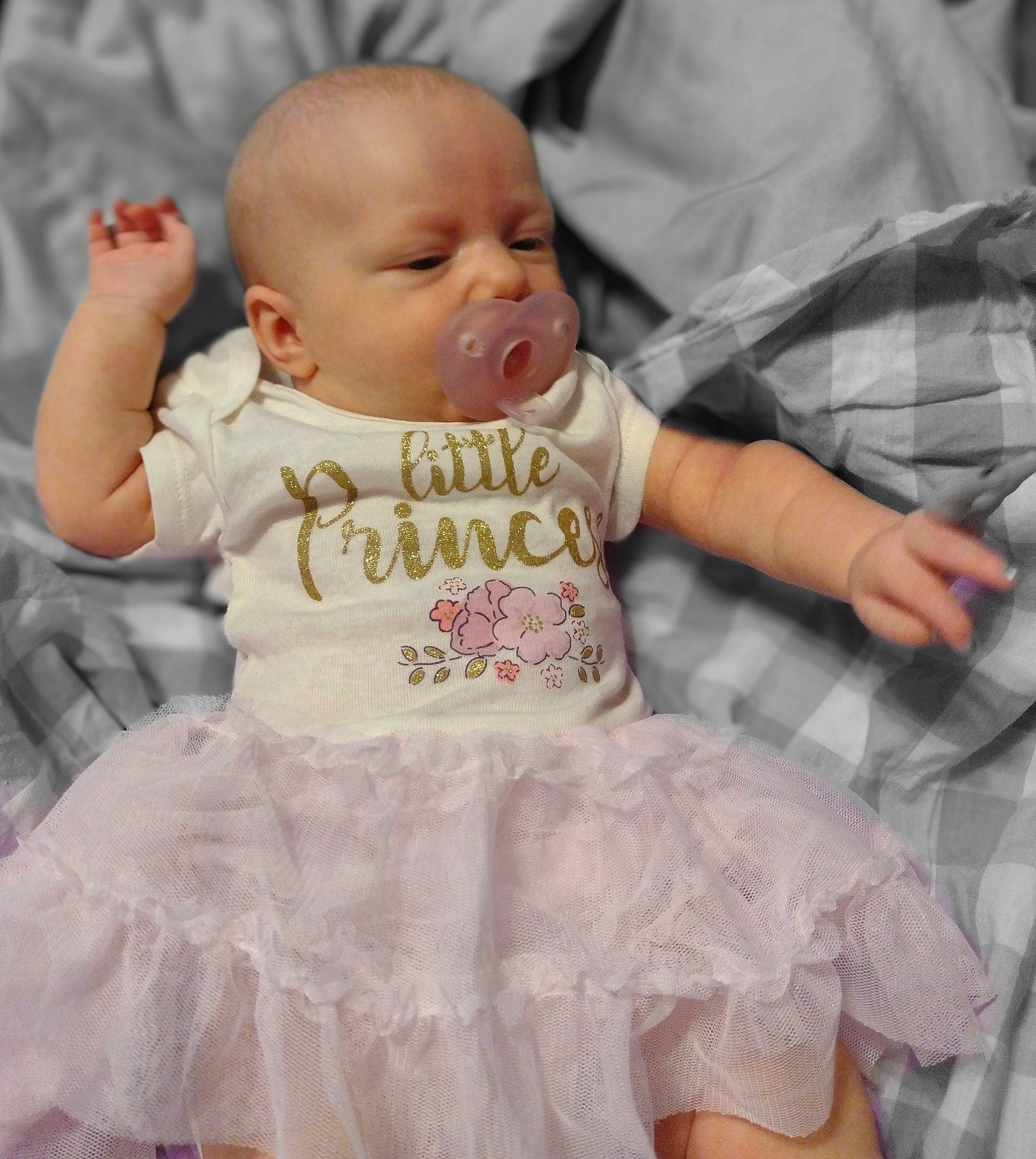 Lilith is registered to the contest to win money with this photo: baby, baby_products, baby_toddler_clothing, cheek, child, comfort, finger, happy, head, iris, pattern, person, pink, product, ruffle, sitting, skin, sleeve, t_shirt, textile