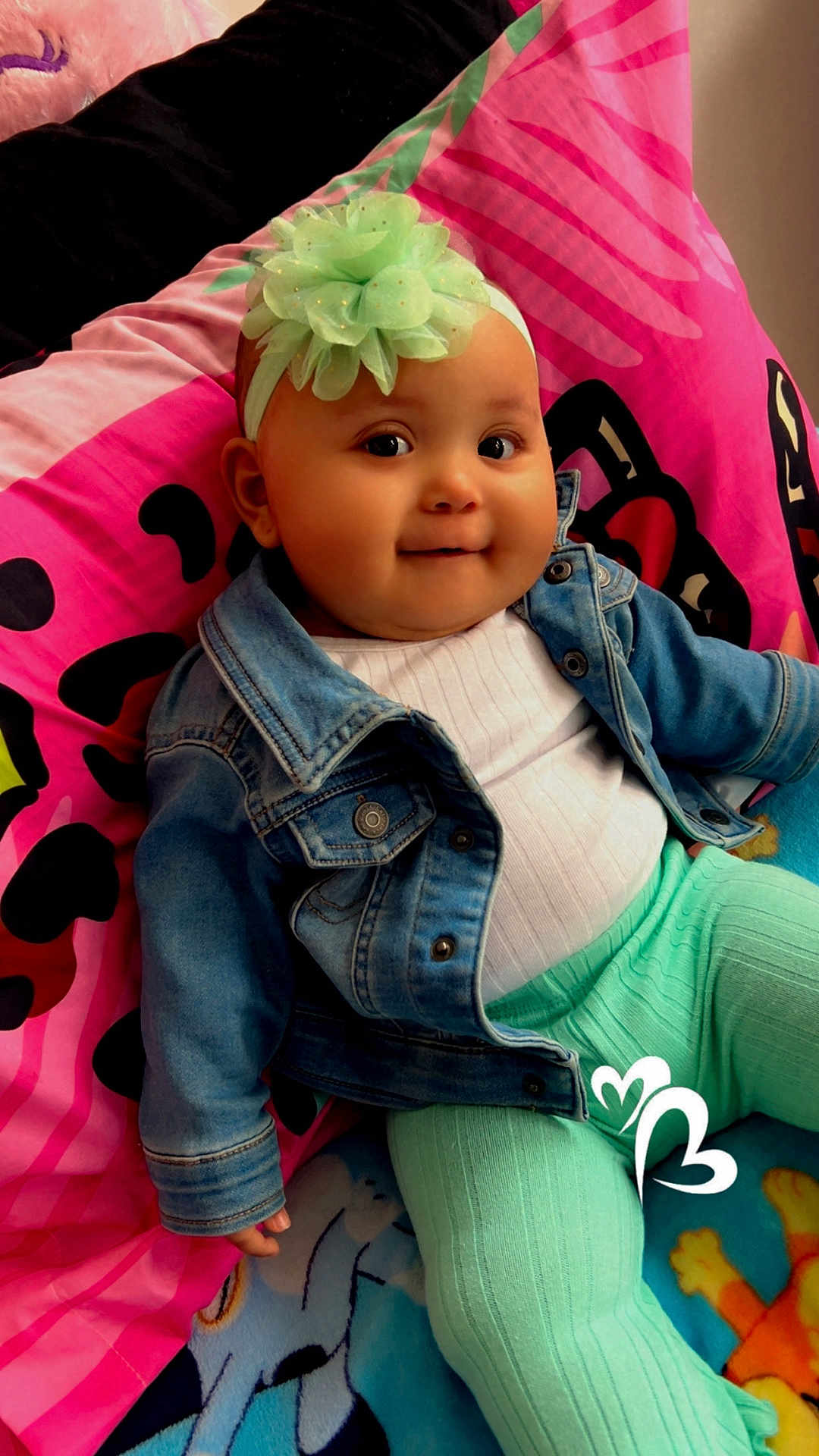 Kaylanee joined the competition — help win amazing prizes! baby, child, denim_jacket, headband, flower, pink_blanket, colorful_blanket, smile, cute, indoors, portrait, happy, toddler, clothing, sitting, furniture, person, cozy, face, playful