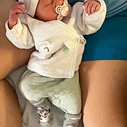 Kahyna participe au concours pour gagner de l'argent avec cette photo : adult, baby, bed, blanket, comfort, cozy, cute, hat, indoors, infant, legs, mint_green_pants, pacifier, peaceful, resting, sleeping, socks, soft_lighting, toddler, white_clothing