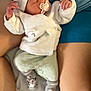 adult, baby, bed, blanket, comfort, cozy, cute, hat, indoors, infant, legs, mint_green_pants, pacifier, peaceful, resting, sleeping, socks, soft_lighting, toddler, white_clothing