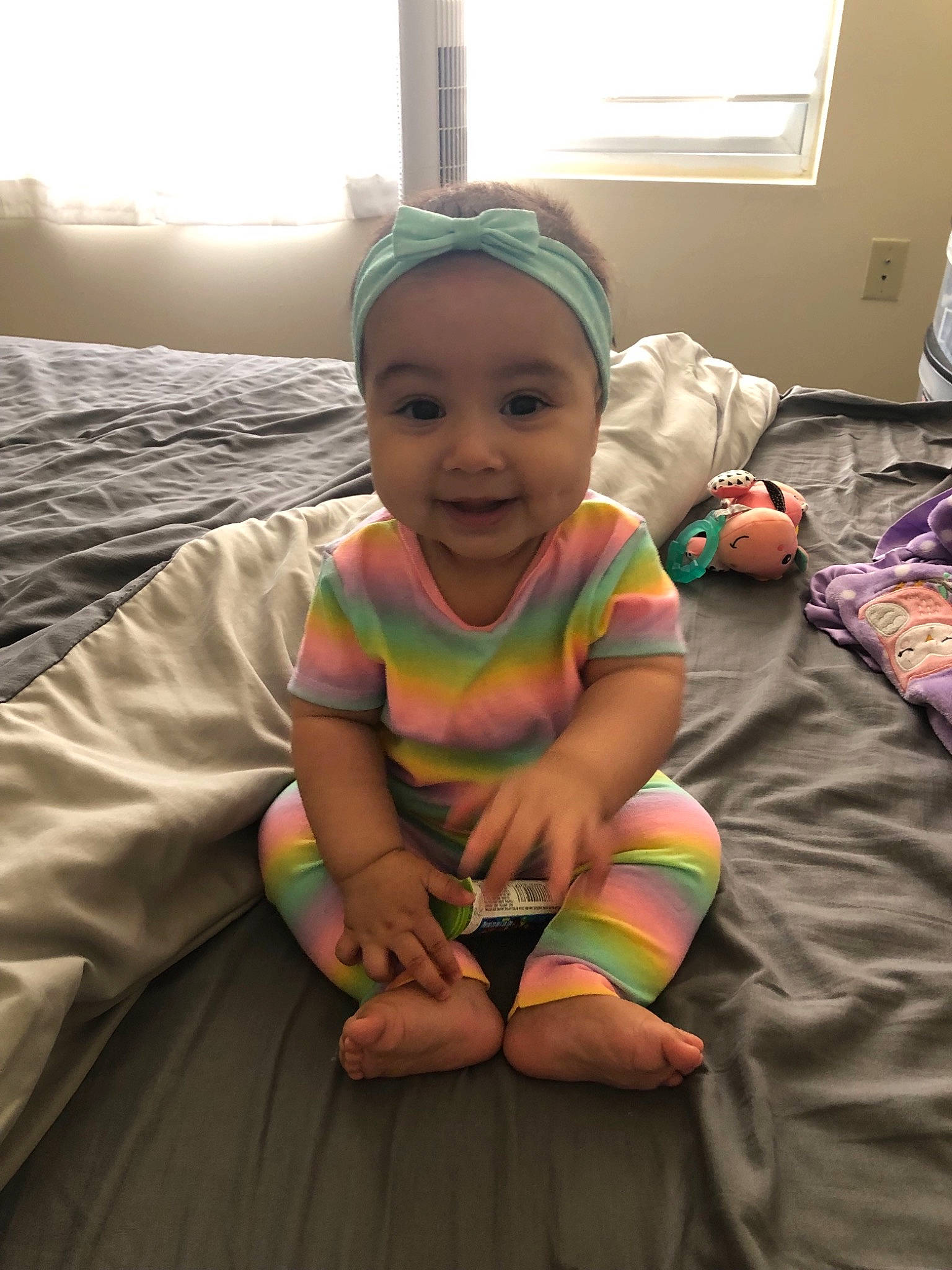 Athena is registered to the contest to win money with this photo: arm, baby, child, fun, happy, head, leg, person, play, sitting, skin, smile, toddler, vacation