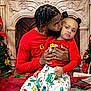child, adult_male, father, toddler, christmas, holiday_pajamas, matching_outfits, red_clothing, fireplace_backdrop, christmas_tree, holiday_decor, kiss, hug, braided_hair, pigtails, beard, plaid_blanket, living_room, portrait, festive