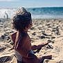 Cataleya a rejoint le concours — aidez-le/la à gagner de superbes lots ! toddler, child, beach, sand, ocean, water, sunlight, curly_hair, bracelet, diaper, bare_skin, sitting, natural_light, outdoor, coast, summer, relaxation, vacation, shore, waves