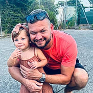 Cataleya a rejoint le concours — aidez-le/la à gagner de superbes lots ! child, toddler, man, outdoor, smiling, hugging, dress, headband, sunglasses, watch, sandals, concrete, fence, trees, summer, playground, happy, family, casual, portrait