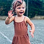 toddler, child, dress, headband, outdoor, smiling, happy, sandals, blue_eyes, curly_hair, waving, pavement, daylight, nature, casual_clothing, person, young_child, summer, playful, footwear