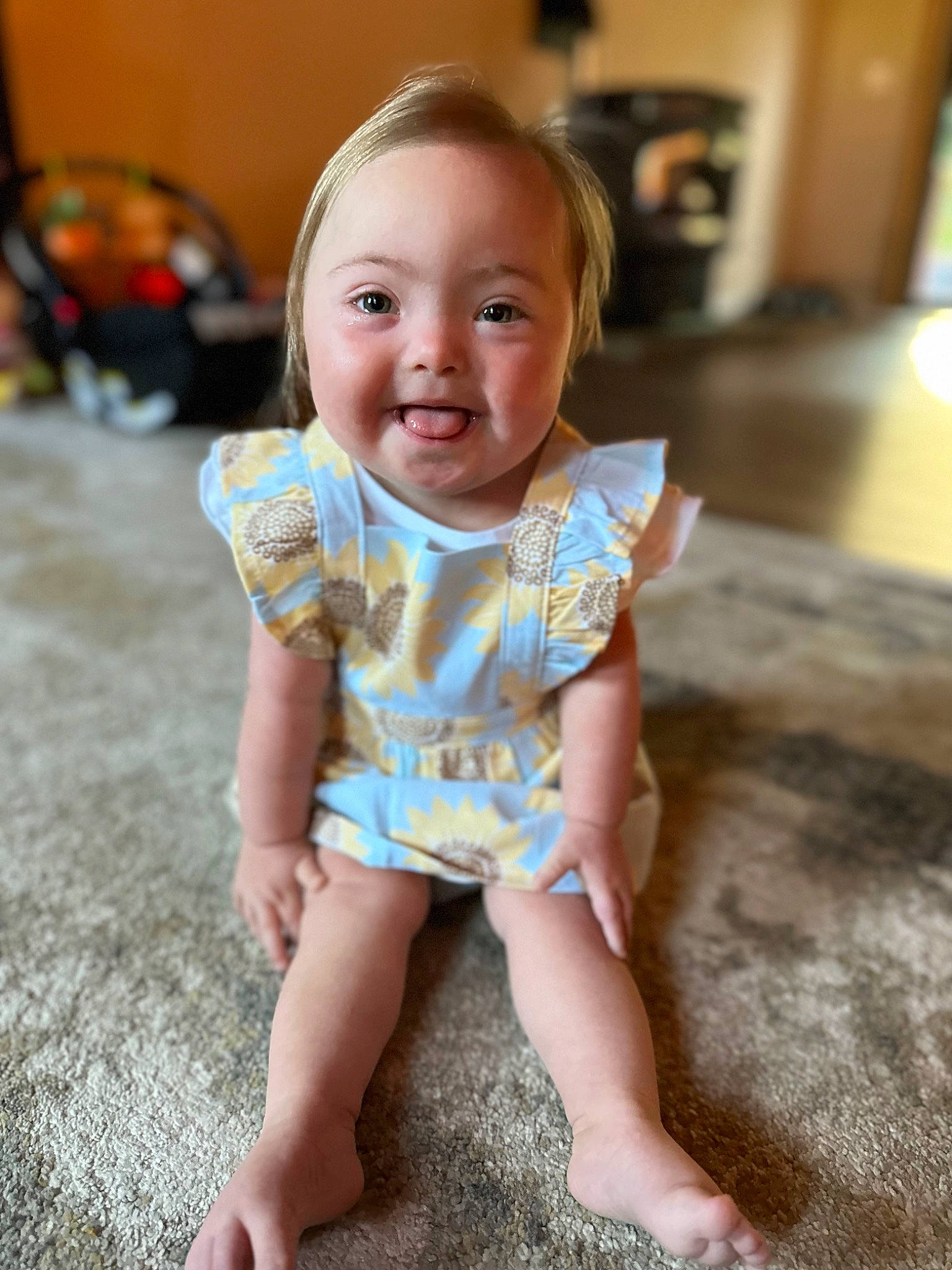 Francesca is registered to the contest to win money with this photo: baby, baby_toddler_clothing, cheek, child, eye, face, floor, flooring, fun, hair, happy, head, human_leg, iris, joy, pattern, person, skin, sleeve, smile