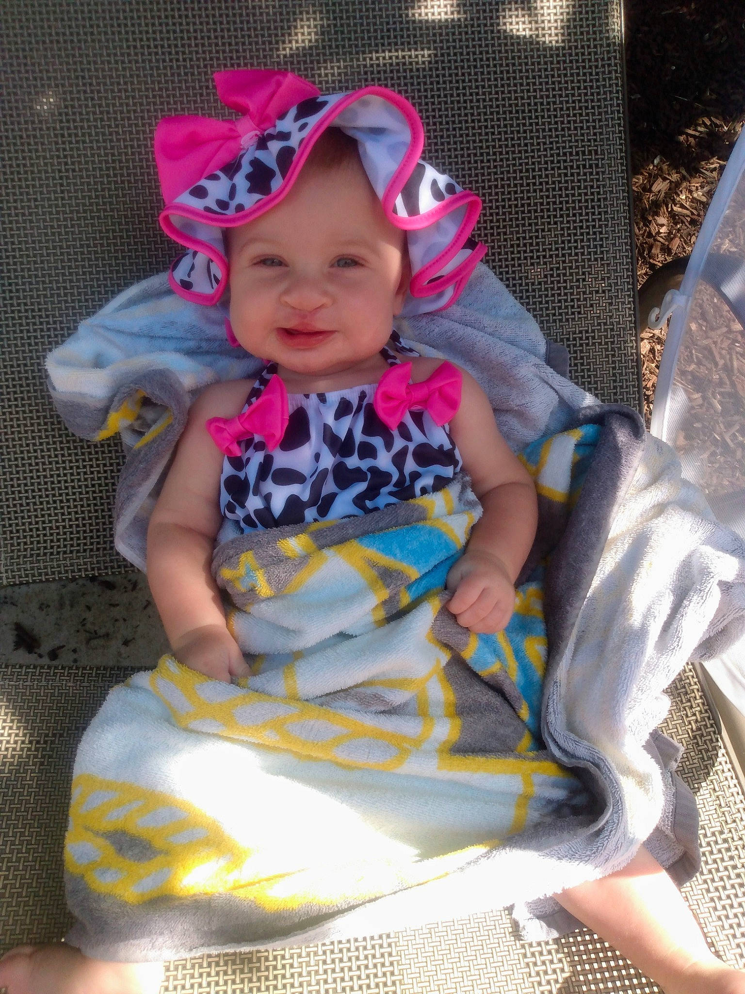 Denaleigh Lane Foor joined the competition — help win amazing prizes! baby, baby_carriage, baby_products, baby_toddler_clothing, cap, child, comfort, fun, goggles, grass, headwear, human_leg, joy, lap, leisure, person, pink, purple, recreation, sitting