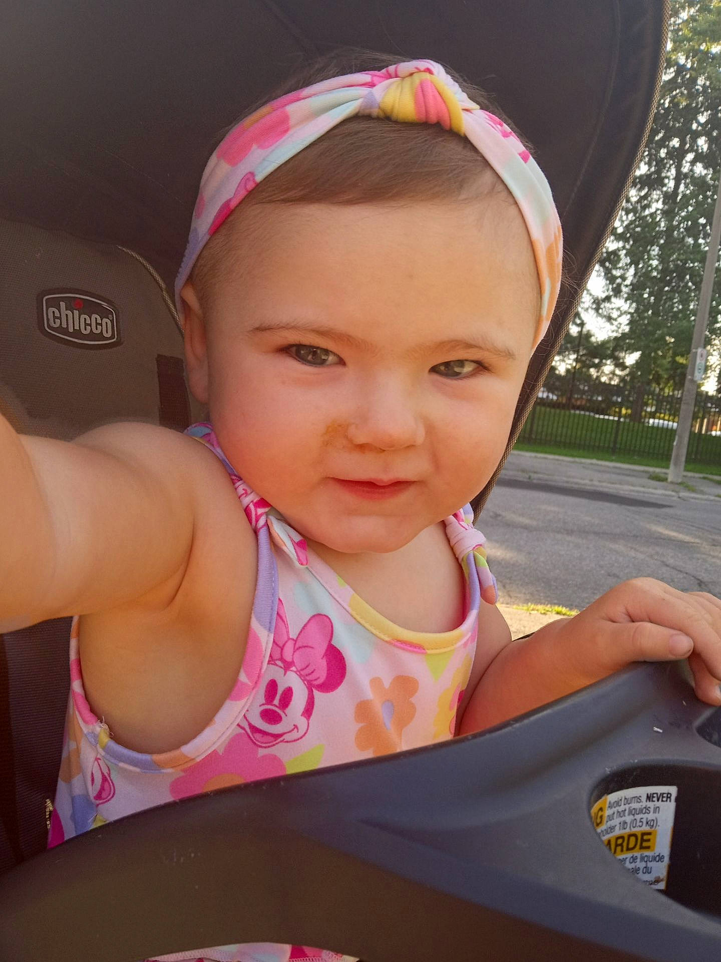 Summer is registered to the contest to win money with this photo: auto_part, cap, car_seat, child, fashion_accessory, fun, happy, headband, leisure, lip, magenta, person, personal_protective_equipment, pink, recreation, skin, steering_wheel, toddler, tree, vacation