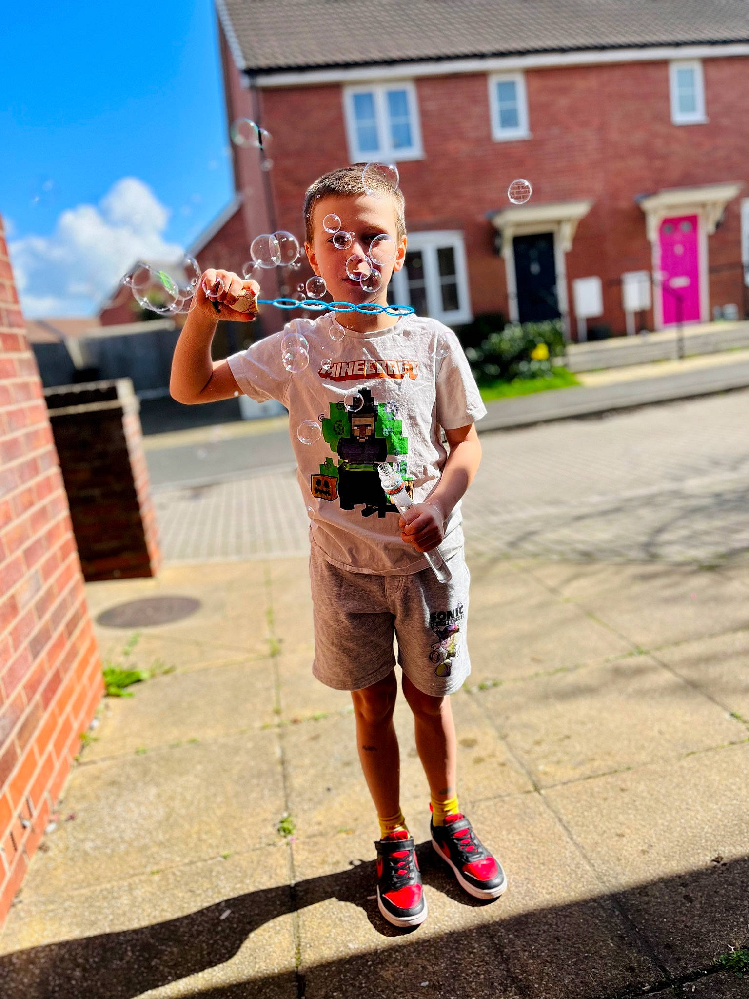 Keegan joined the competition — help win amazing prizes! asphalt, cloud, electric_blue, eyewear, face, fun, happy, human_leg, leisure, musical_instrument, pedestrian, person, recreation, road, shorts, sidewalk, sky, street, t_shirt, travel