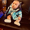 Paris joined the competition — help win amazing prizes! baby, child, blue_jacket, sitting, leather_chair, curious, indoors, cute, footwear, infant, person, portrait, clothing, wooden_floor, furniture, looking_up, small_shoes, hooded_jacket, expression, seated