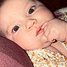 Paris joined the competition — help win amazing prizes! baby, infant, face, hand, blue_eyes, cushion, purple, floral_clothing, close_up, skin, cheek, expression, child, indoors, portrait, young, cute, resting, thoughtful, soft_lighting