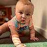 baby, crawling, child, indoor, carpet, onesie, nike, curious, portrait, soft_light, shadow, hand, face, infant, expression, person, floor, background_blur, skin, short_hair