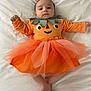 Sofia participe au concours pour gagner de l'argent avec cette photo : baby, infant, pumpkin_costume, orange_tutu, leaf_collar, lying_down, white_bedspread, cute, child, portrait, costume, holiday, halloween, tulle_skirt, crossed_legs, small_feet, expressive_face, indoors, soft_lighting, adorable