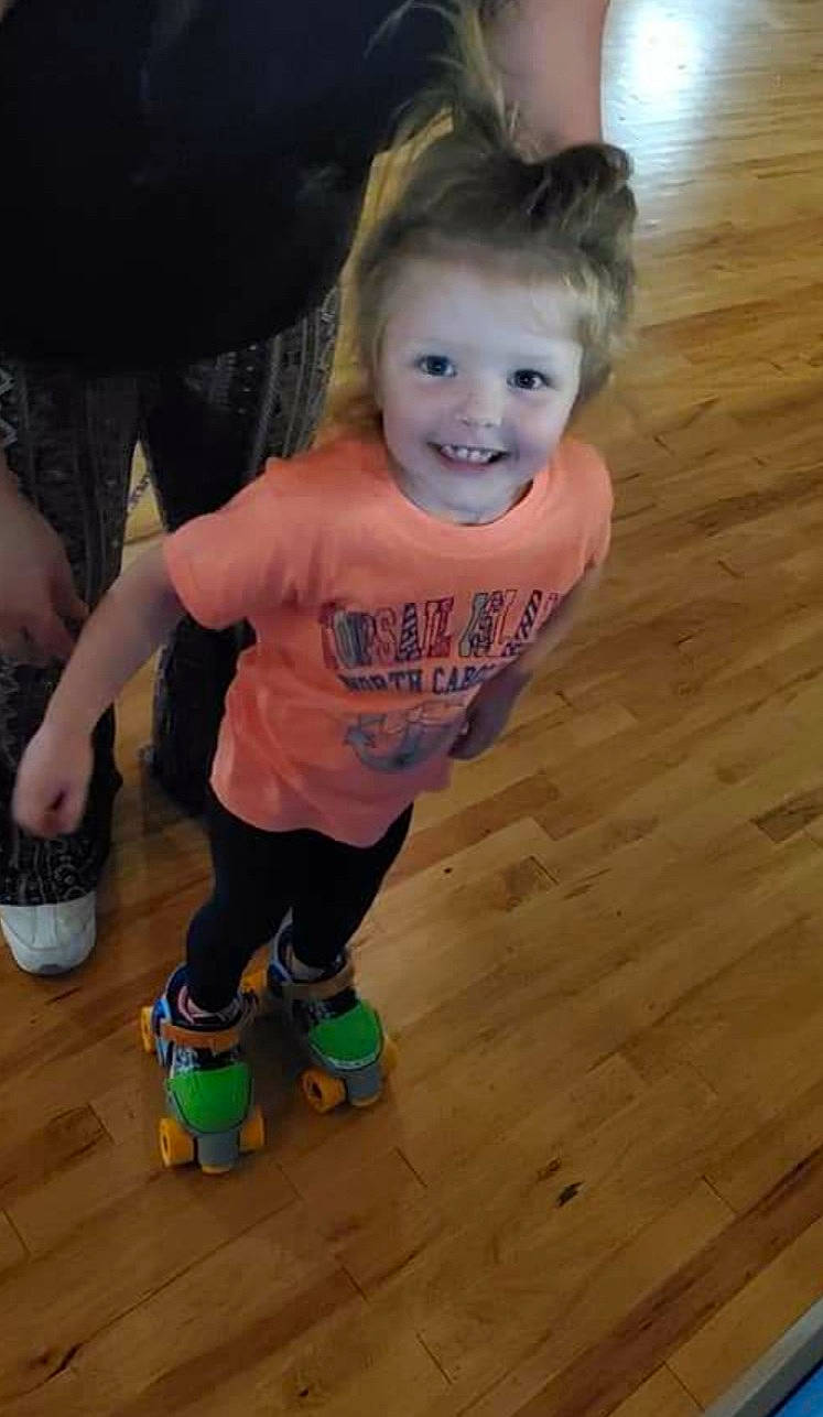 Gracie is registered to the contest to win money with this photo: child, floor, flooring, footwear, hardwood, joy, leg, person, play, skin, smile, standing, toddler, wood