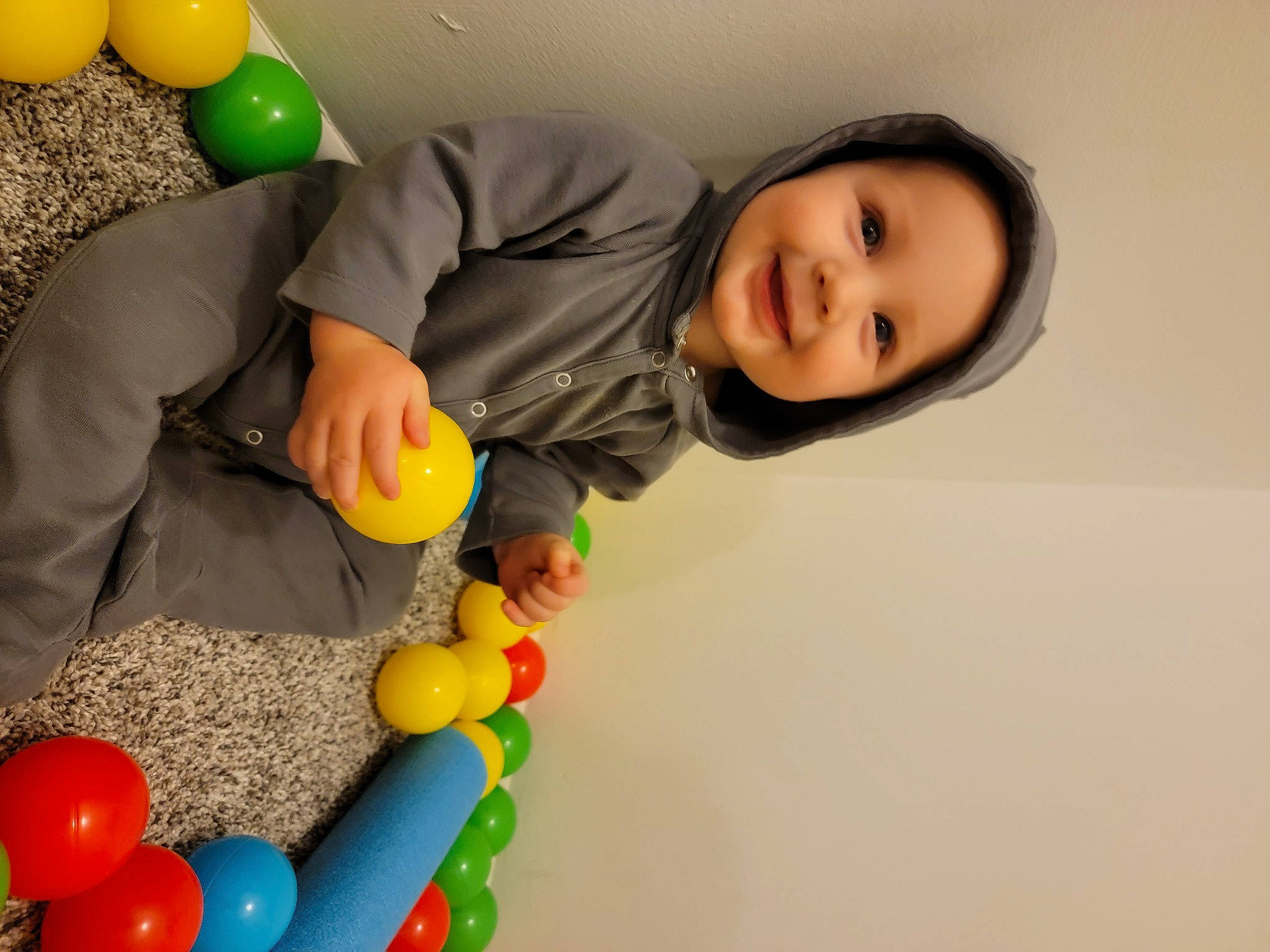 Ledger is registered to the contest to win money with this photo: baby, baby_playing_with_toys, baby_products, baby_toys, ball, ball_pit, balloon, child, event, fun, happy, joy, leisure, party, party_supply, person, photograph, play, room, smile