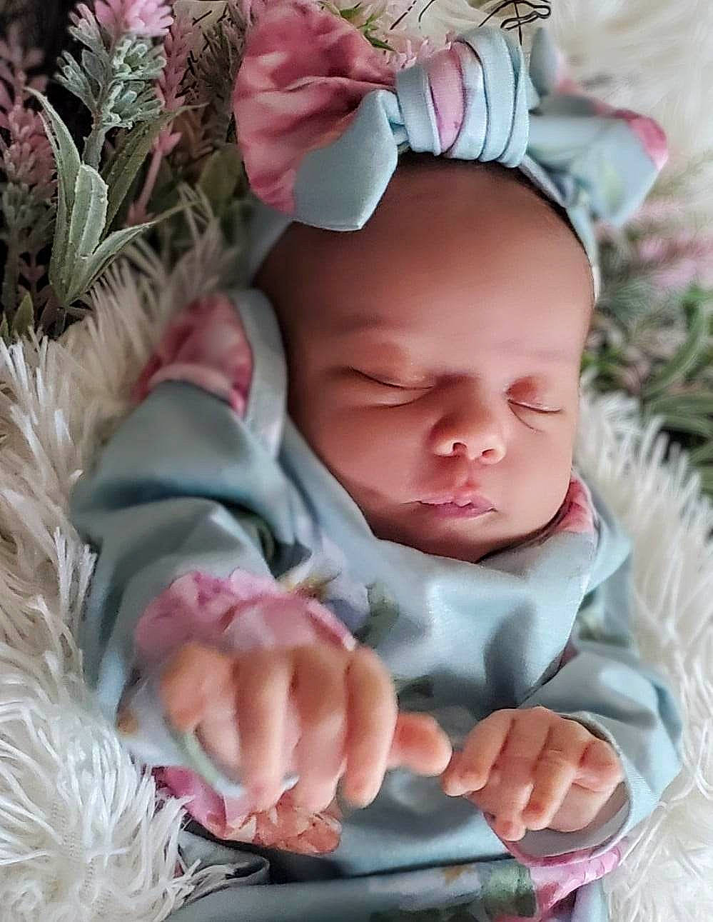 Zeniah is registered to the contest to win money with this photo: baby, baby_products, baby_toddler_clothing, botany, cheek, child, eye, face, finger, gesture, grass, happy, head, leaf, person, pink, plant, skin, textile, toddler